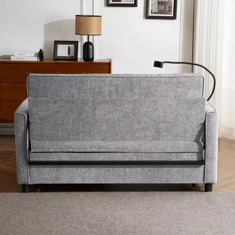 Canapé 2 places convertible Whisen 56, avec coussins de dossier réversibles, poches latérales, ports USB et support de téléphone.