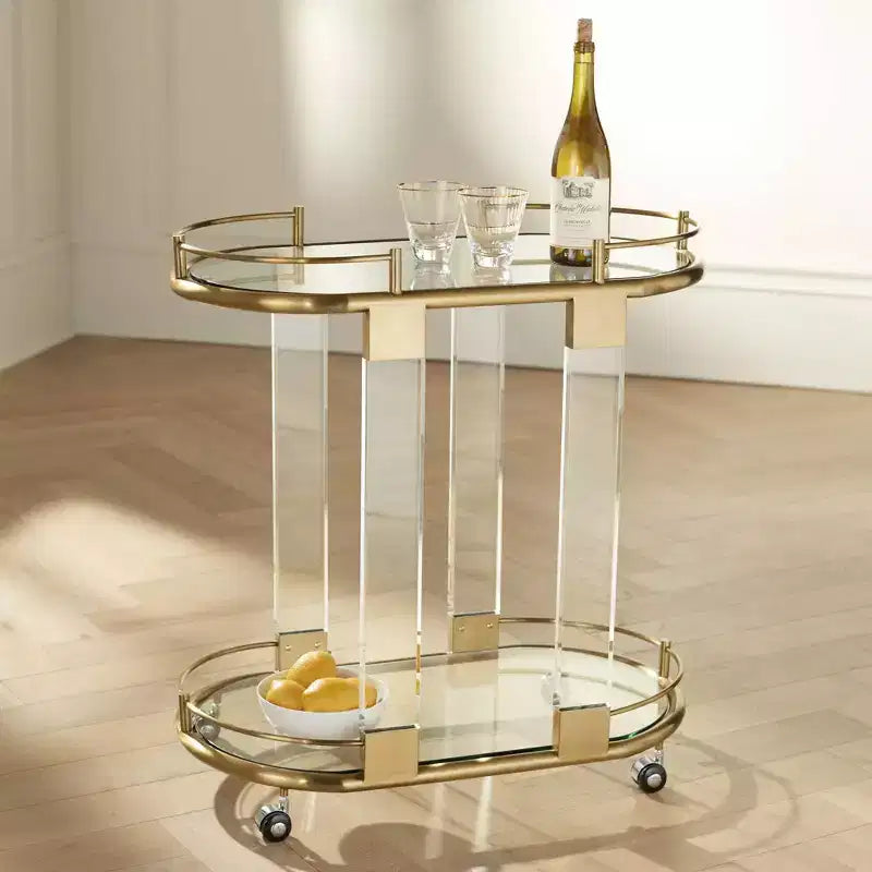 55 Downing Street Chariot de bar ovale Adaline de 75 cm de large en acrylique transparent et or